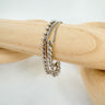 Coimbra bracelet silver layered chain and bead bracelet by Matte displayed on a wooden stand.
