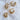 Colette hoop earrings in gold-plated small and medium sizes displayed on a white marble surface