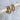 Colette hoop earrings displayed on wood surface