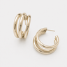 Collete Hoop Earrings featuring polished gold-plated triple-band hoop earrings with a layered stacked-hoop design, rounded high-shine finish, lightweight construction, secure hinged closure, and a bold yet timeless silhouette.