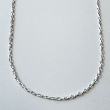 Crescent chain necklace by Matte in white finish, minimalist design

