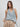 Cristine polka dot halter top with draped cowl neckline styled with beige wide-leg pants.