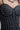 Detailed view of crystal embellishments on black corset top, highlighting sparkle.