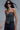 Model wearing Crystal Embellished Corset Top in black with silver crystals, styled with jeans and accessories.