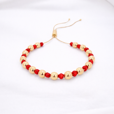 Darcity Beaded Bracelet red and gold beaded bracelet variation flat lay on neutral background showing vibrant color accents and lightweight structure.