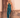 Model wearing teal sequin Daria Jumpsuit with halter neckline and side slit — Matte Concept Store
