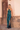 Model wearing teal sequin Daria Jumpsuit with halter neckline and side slit — Matte Concept Store
