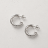De Haan Hoop Earrings featuring polished silver-plated hoop earrings with a twisted rope-inspired texture, rounded hoop silhouette, mirror finish, secure hinged closure, lightweight design, and timeless everyday style.