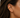 Debbie Ear Cuff worn on ear showing no-piercing fit and bold gold stacked jewelry look.