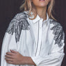 Elaine Shirt oversized white button-front shirt with black embroidered shoulder detailing worn by model.