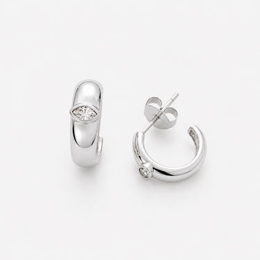 Eleonora Hoop Earrings featuring polished silver mini hoop earrings with a smooth rounded silhouette, sparkling pavé crystal accent, mirror finish, secure hinged closure, lightweight design, and elegant everyday style, displayed on a soft white background.