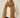 Woman wearing the Eto Pashmina in warm camel chunky knit wool, soft neutral background, cozy editorial style – Matte.
