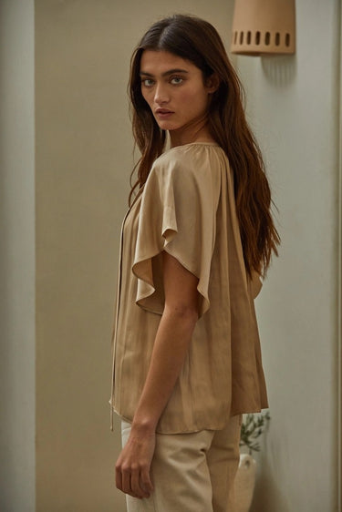 Etta Blouse side view highlighting draped silhouette and soft feminine fit.