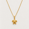 Exuma Necklace featuring a polished gold-filled sea turtle pendant suspended from a delicate chain, styled on a light neutral background showcasing its timeless coastal-inspired design.