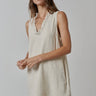 Model wearing natural linen Ezeiza Dress with fringed V-neckline.