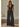 Model wearing Fares Jumpsuit in charcoal shimmer fabric with v-neckline and wide leg