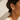 Filippa Huggie Earrings two-tone gold and silver mini huggie hoops worn on model ear.