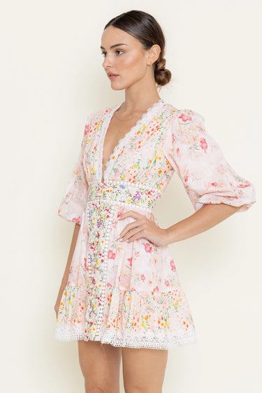 Woman wearing a floral dress against a plain background