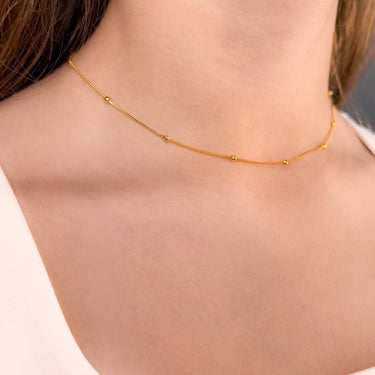 Model wearing Follow gold plated beaded chain necklace by Matte, minimalist jewelry