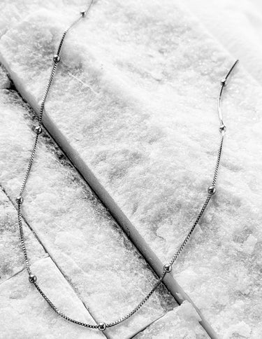 Follow silver chain necklace by Matte, delicate beaded minimalist chain on marble