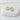 Gardenia Huggie Earrings by Matte, pair of gold plated huggie hoops on white stone surface