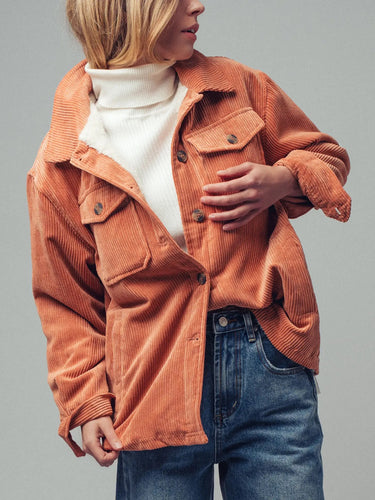 Close-up of the Genova peach corduroy jacket showing the plush sherpa-style lining, button-front closure, and textured corduroy fabric.
