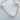 A gold-plated bracelet with white pearls and gold beads, displayed against a white background.