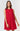 A woman wearing a vibrant red, sleeveless summer dress with a floral eyelet pattern, featuring a button-down front.