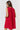 Model wearing red Gigi Dress with sleeveless cut and eyelet texture, back view