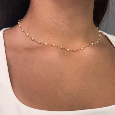 Model wearing Glinda gold plated necklace with pearls close-up