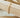 Gold flat chain bracelet on wooden display – Matte jewelry