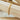 Gold flat chain bracelet on wooden display – Matte jewelry