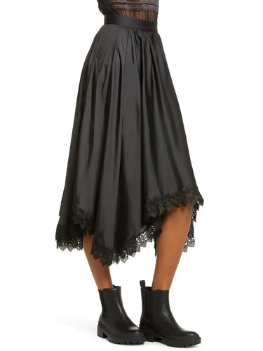 Black lace-trimmed skirt worn by a person on a white background