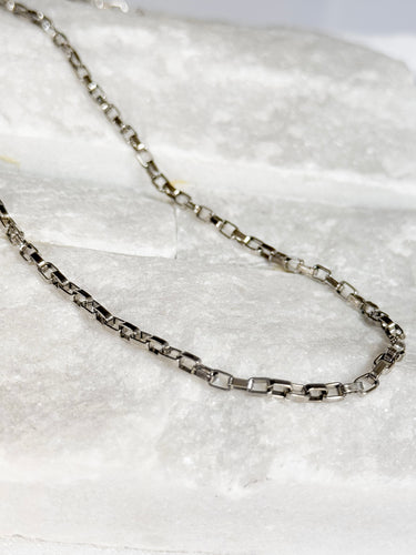 Halo Necklace by Matte, silver rectangular link chain on white marble surface
