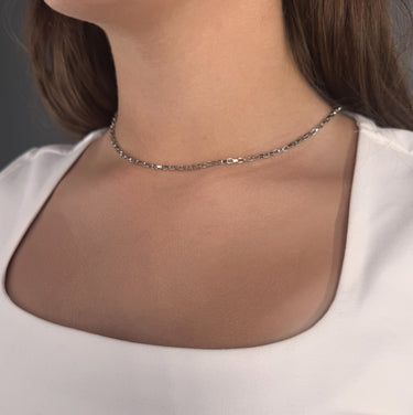Model wearing Halo Necklace by Matte, silver rectangular link chain, 16 inch