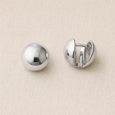 Halott Huggie Earrings in silver featuring a glossy polished finish and dome silhouette