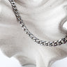 Harika Necklace in silver thick chain design by Matte on textured display stand