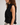 Side view of the black Harpenter Top showing its sleeveless silhouette and cascading ruffle details.
