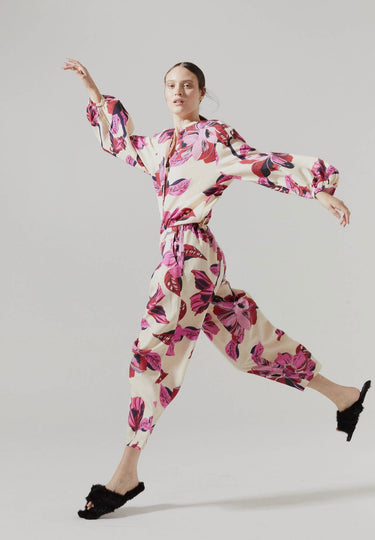 Model wearing Hibiscus Pant with ivory base and bold magenta floral print.