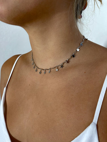 Model wearing Hilaria silver star necklace by Matte, delicate celestial choker