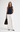 Woman wearing the Hotflix navy denim sleeveless top with white wide-leg pants and a brown handbag.