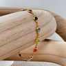 Howl gold chain bracelet with multicolor gemstones on wooden display – Matte jewelry