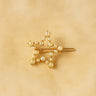 Idle Hair Clip — gold star-shaped hair accessory with pearl details on neutral beige background.