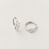 Idon Huggie Earrings featuring polished silver 12mm huggie hoops with delicate star accents and a secure hinged closure, styled on a white background showcasing their minimalist everyday design.