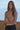 Ikara Top fitted ribbed mock neck top in beige with long sleeves and minimalist styling.