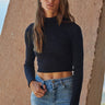Ikara Top fitted long sleeve top in black styled with denim jeans.