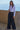 Ikara Top white long sleeve ribbed top styled with wide-leg trousers.