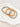 Three beaded bracelets in silver, gold, and bronze on a white stone surface by Matte