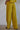 Ithaca Pant lightweight ribbed flowy pants in bright olive mustard.