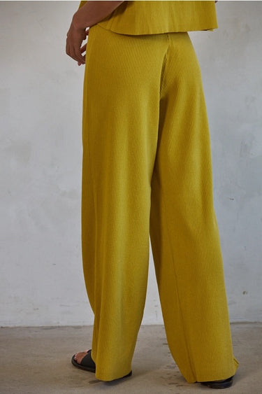 Ithaca Pant lightweight ribbed flowy pants in bright olive mustard.